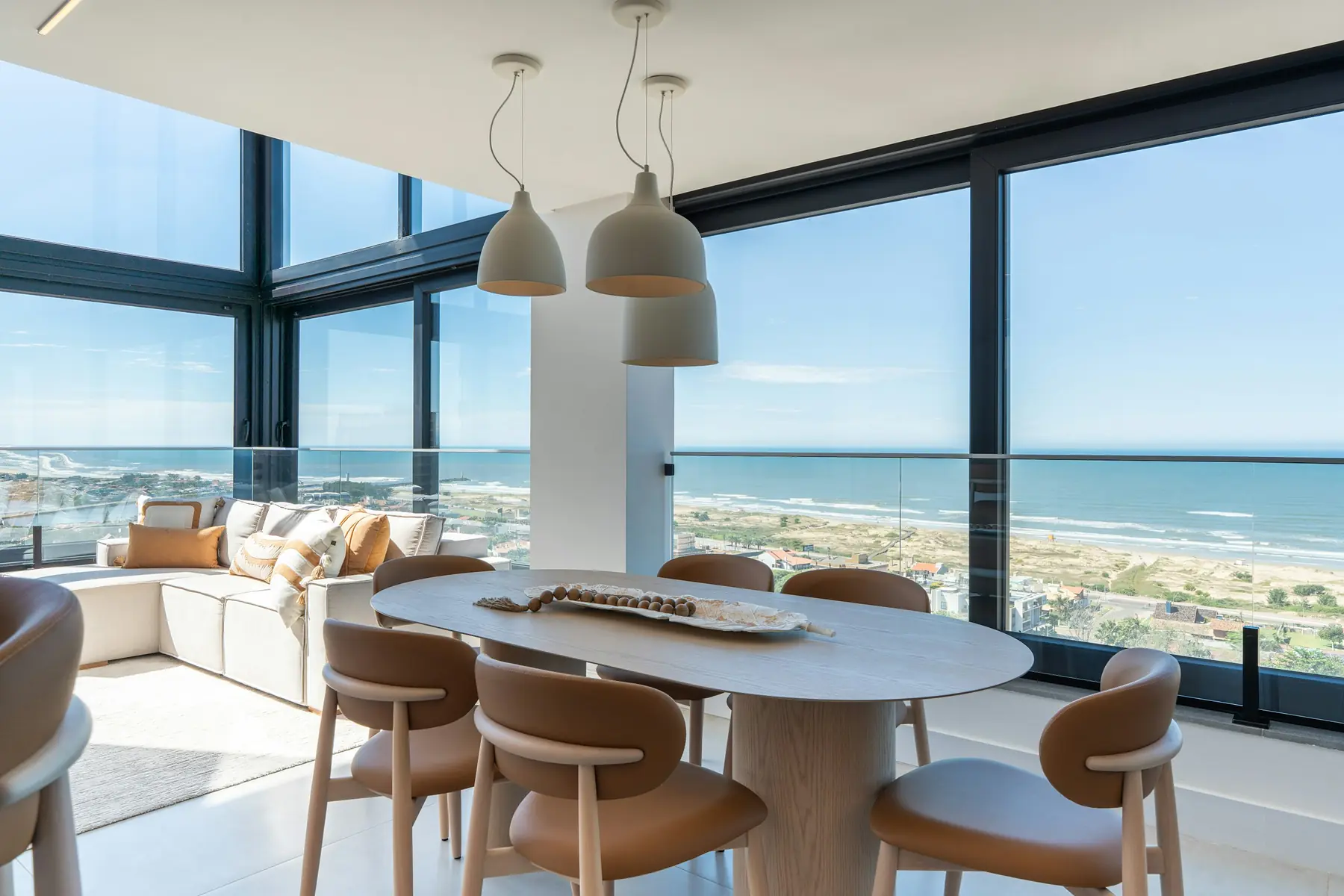 A bright dining room with a view over the beach and sea